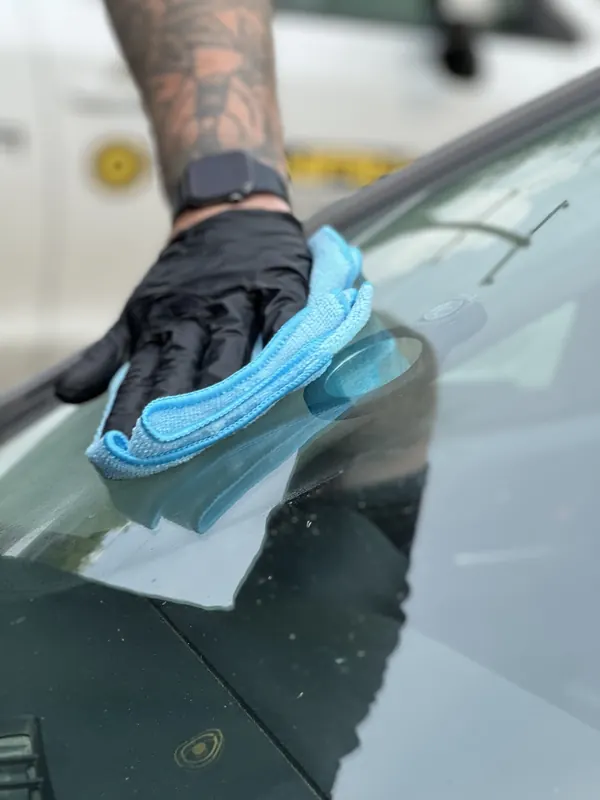 Windshield chip being repaired with professional repair equipment