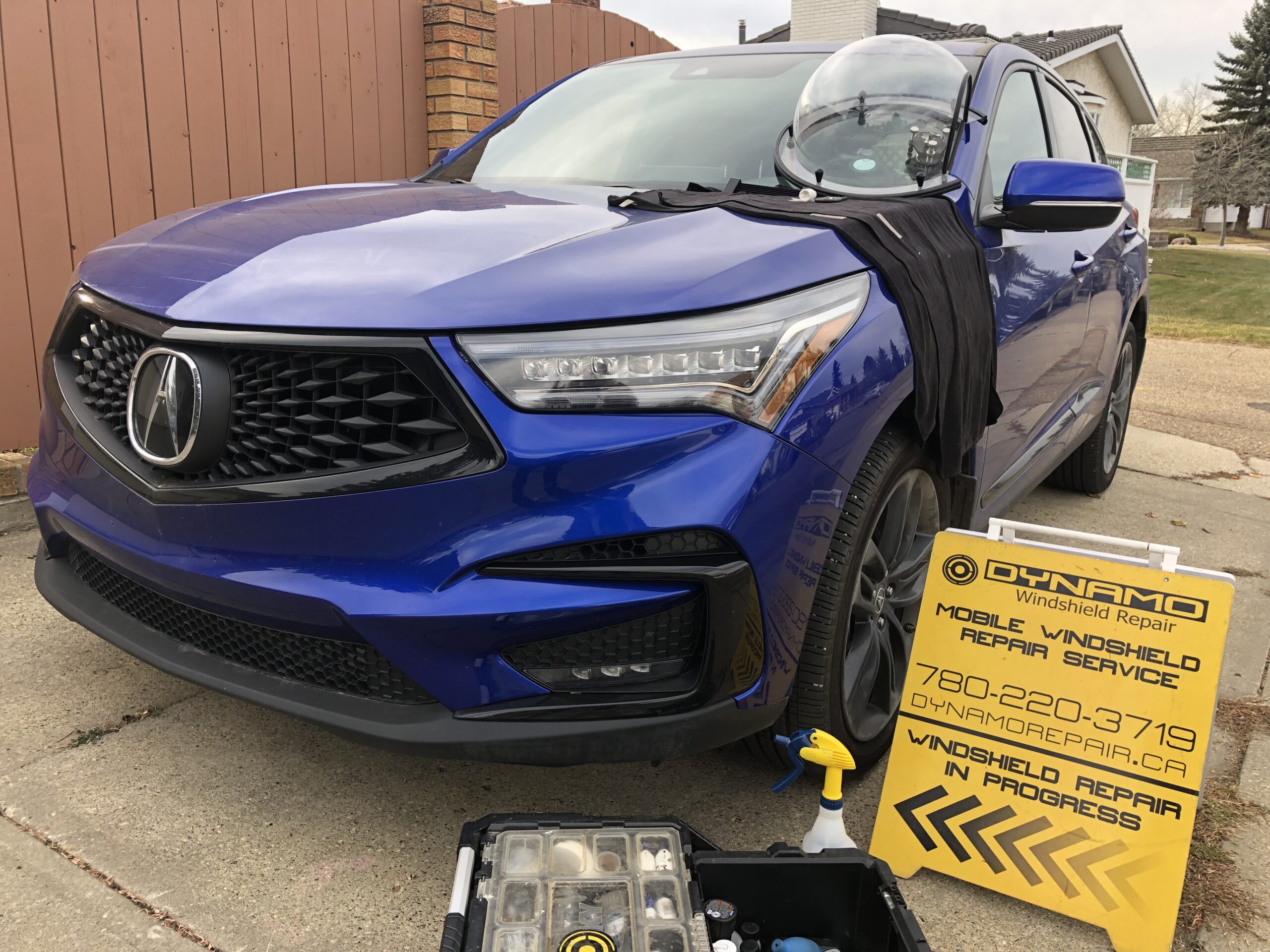 windshield chip repair on a blue Acura 