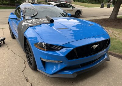 Windshield repair on a blue Ford Mustang